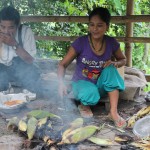 Lady cooking maize/corn, Sikkim, India