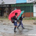 School children farewells in the rain, Yuksom, Sikkim, India