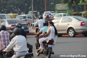 Roundabout, overloaded motorbike, baby, traffic, New Delhi